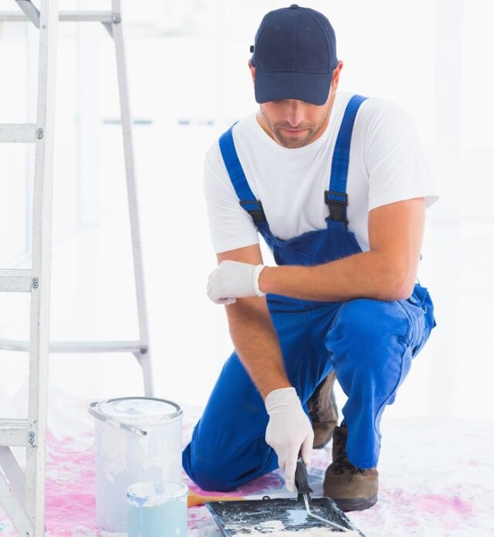 [freepicdownloader.com]-handyman-using-paint-roller-tray-home-large